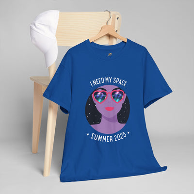 Blue Astronaut Space Vibes Tee with galaxy graphic design, hanging on a chair with a white cap.