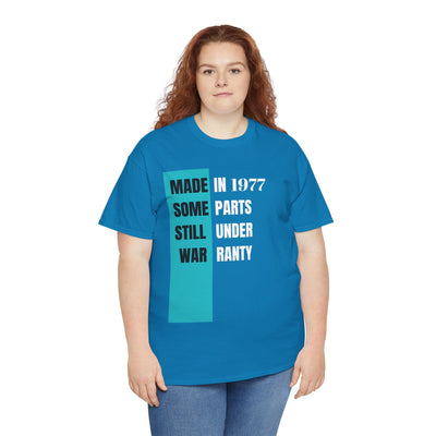 Humorous vintage style tee with "Made In Some Parts Still Under Warranty" slogan, perfect birthday gift.