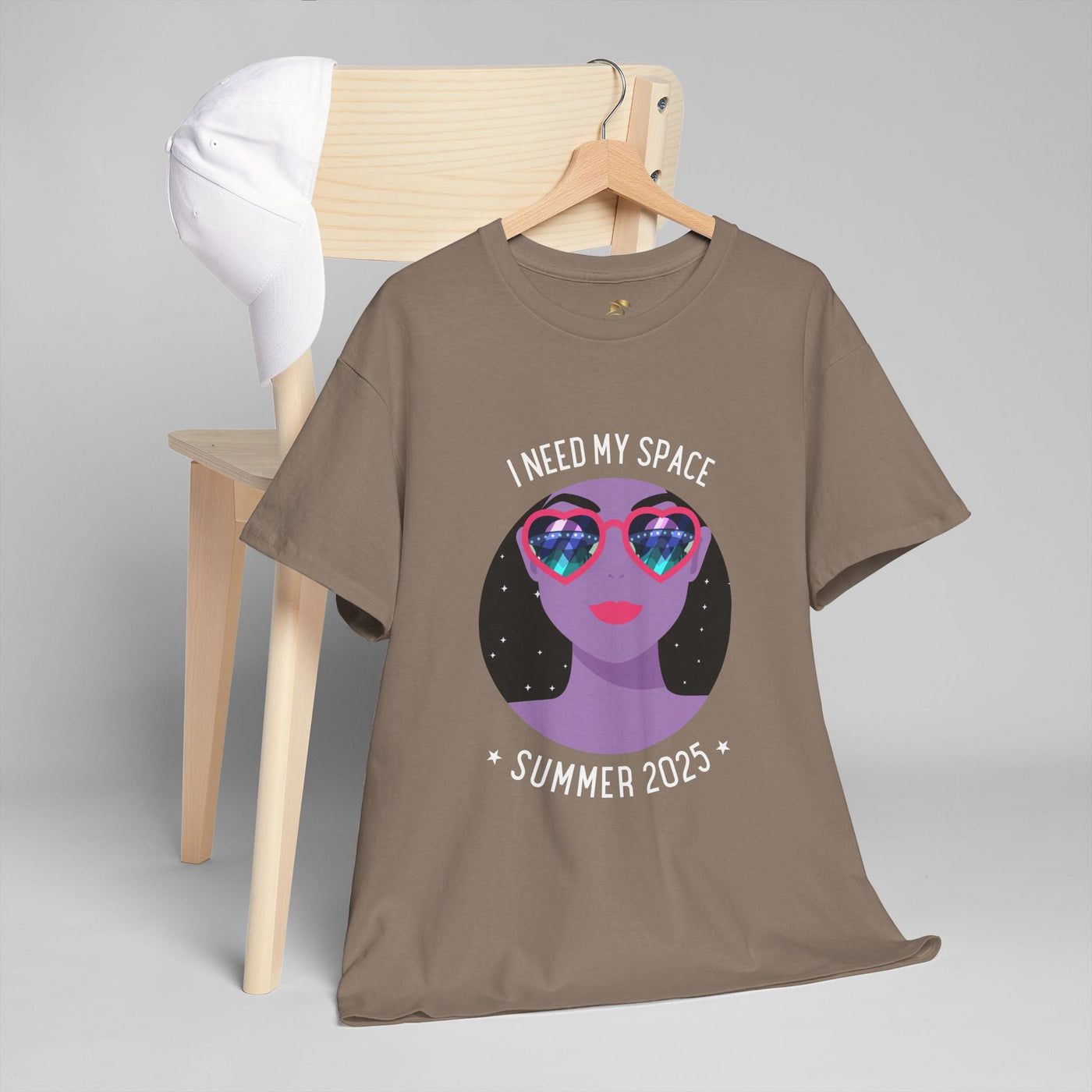 Astronaut Space Vibes Tee with galaxy graphic on chair, perfect for space enthusiasts.