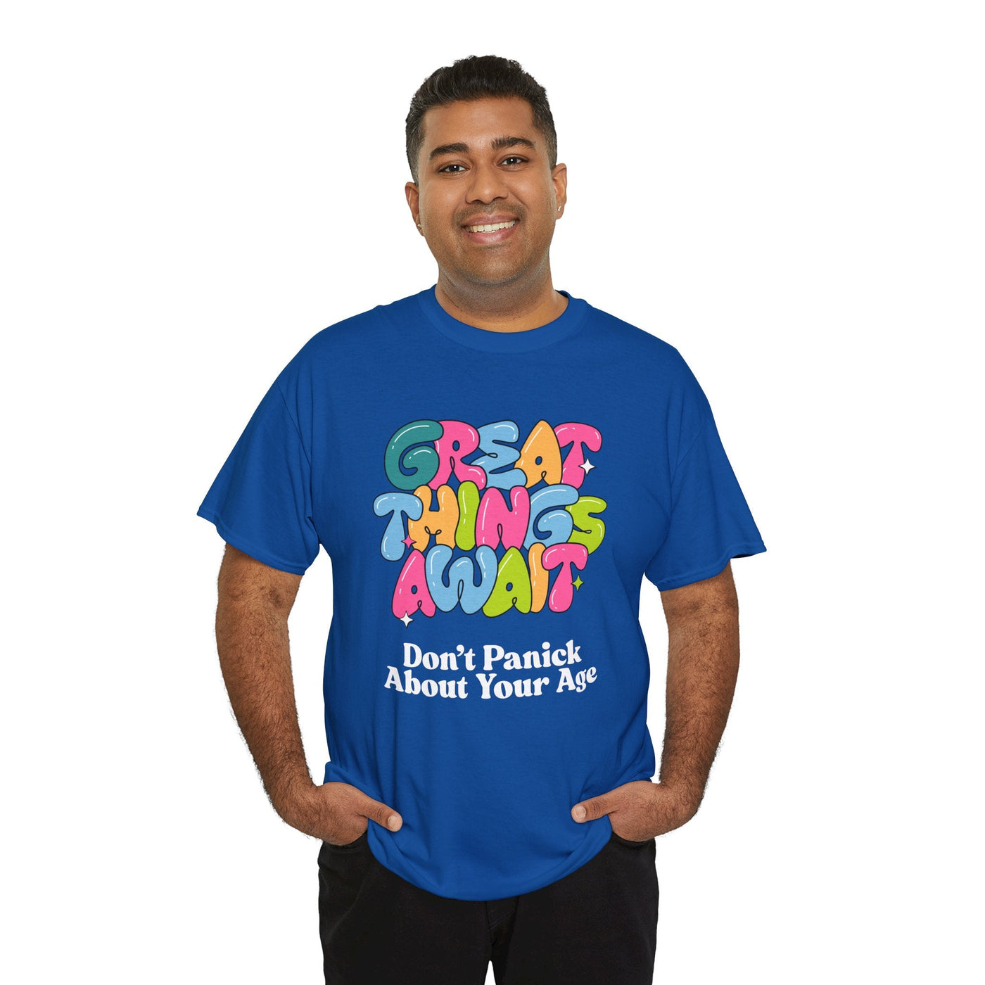 Positive vibes blue t-shirt with "Great Things Await, Don't Panic About Your Age" message in colorful, bubbly font.