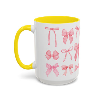 Colorful coffee mug with pink coquette bow design, vibrant yellow interior and handle, perfect for Mother's Day.