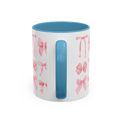 Personalized Mother's Day mug with pink bows and blue interior.
