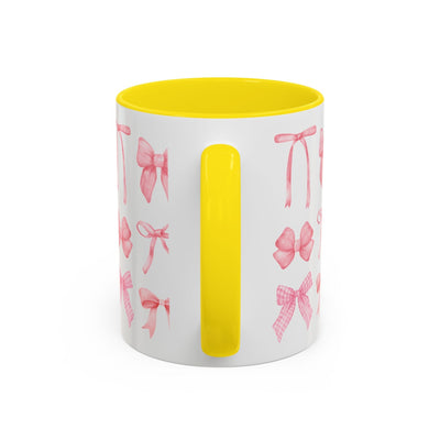 Personalized Mother's Day mug with pink coquette bows and yellow handle.