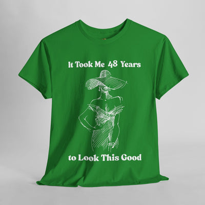 Chic green t-shirt featuring "It Took Me 48 Years to Look This Good" slogan with elegant woman sketch.