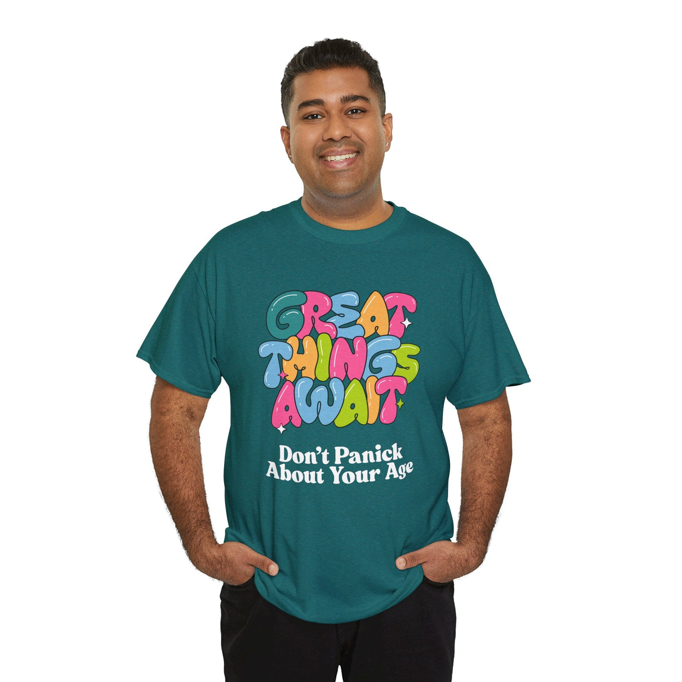 Teal t-shirt with "Great Things Await, Don't Panic About Your Age" in colorful, bubbly letters.