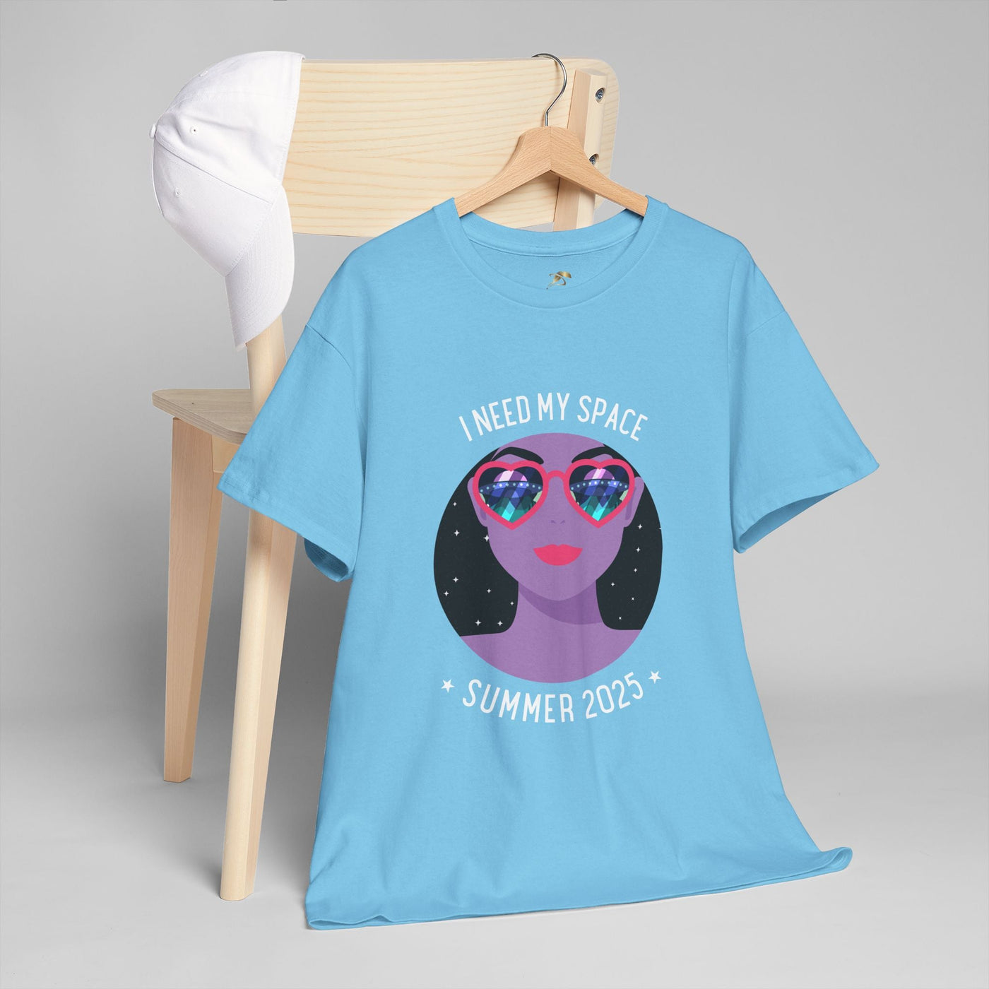 Astronaut Space Vibes Tee with galaxy graphic and "I Need My Space" text, blue shirt displayed on chair.