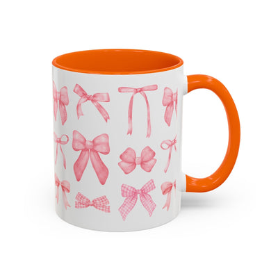 Personalized Mother's Day mug with pink bows, orange handle, and interior.