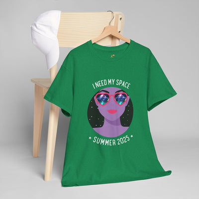 Green Astronaut Space Vibes Tee with galaxy graphic and "I Need My Space Summer 2023" text, hanging on a chair with a white cap.