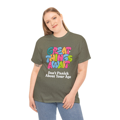 Uplifting T-shirt with "Great Things Await, Don't Panic About Your Age" design, encouraging positive vibes and humor about aging.