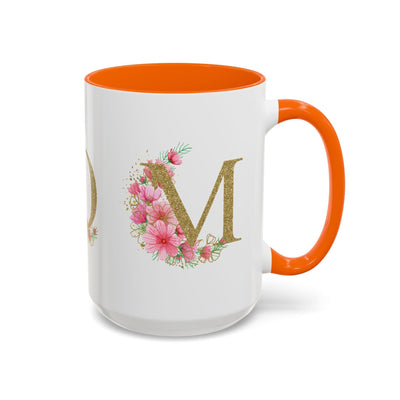 Mother's Day mug with floral "M" design and orange interior, perfect gift for mom.