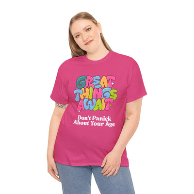 Pink t-shirt with colorful "Great Things Await, Don't Panic About Your Age" design, featuring a cheerful, encouraging message.