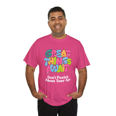 Pink t-shirt with "Great Things Await, Don't Panic About Your Age" in colorful, bubbly font for positive vibes and encouragement.