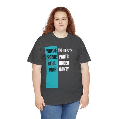 Funny aging t-shirt with "Made In Some Parts Still Under Warranty" slogan, vintage style, humorous birthday gift for adults.
