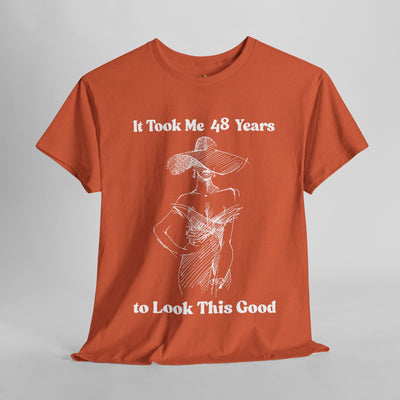 Chic orange t-shirt with elegant woman sketch and "It Took Me 48 Years to Look This Good" slogan, ideal for stylish birthday humor.