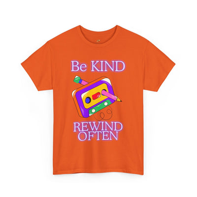 Retro orange t-shirt with "Be Kind, Rewind Often" positive quote and cassette tape graphic, 90s nostalgia vibe.